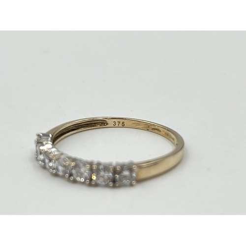 2040 - A 9ct gold CZ seven stone ring, size Q½ - approx. gross weight 1.7g