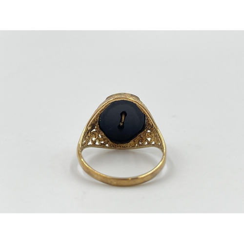 2046 - A hallmarked Birmingham 9ct gold and black onyx pierced Jaguar signet ring, size T - approx. gross w... 