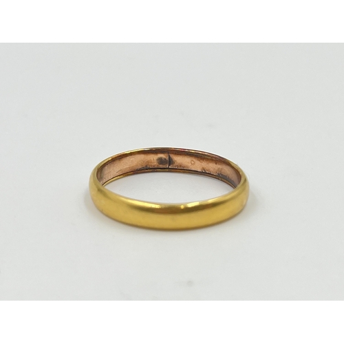 2055 - A yellow metal wedding band, size N½ - approx. gross weight 3.6g