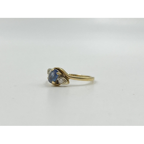 2059 - A hallmarked Birmingham 9ct gold sapphire and diamond bypass ring, size Q - approx. gross weight 2.4... 