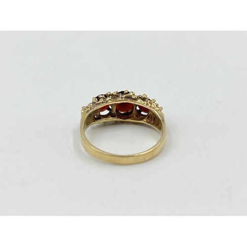 2061 - A mid 20th century Brutalist hallmarked London 9ct gold garnet trilogy ring, dated 1976 and size P -... 