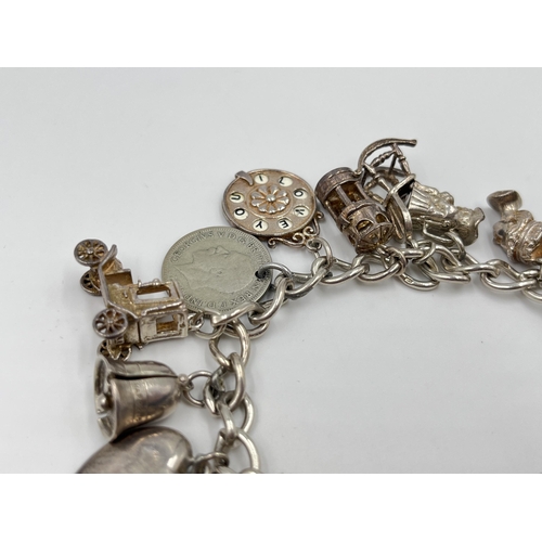 2065 - A hallmarked sterling silver charm bracelet with assorted charms - approx. gross weight 60g