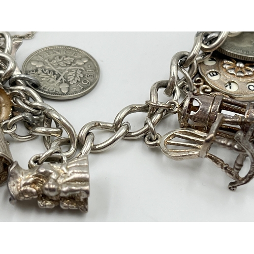 2065 - A hallmarked sterling silver charm bracelet with assorted charms - approx. gross weight 60g