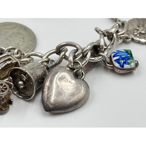 2065 - A hallmarked sterling silver charm bracelet with assorted charms - approx. gross weight 60g