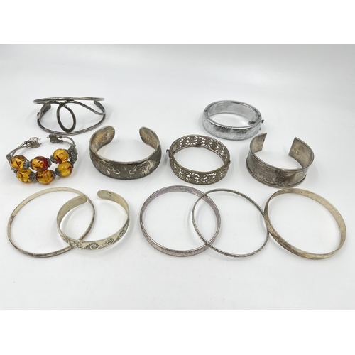 2088 - A collection of white metal bangles and cuff bracelets