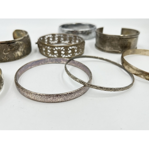 2088 - A collection of white metal bangles and cuff bracelets