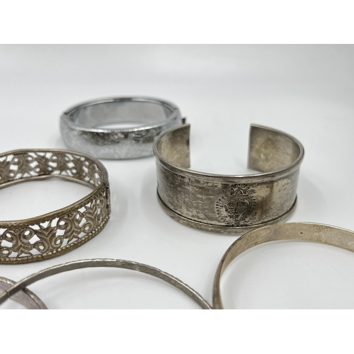 2088 - A collection of white metal bangles and cuff bracelets