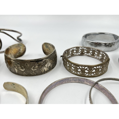 2088 - A collection of white metal bangles and cuff bracelets