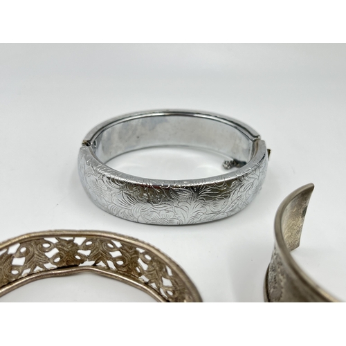 2088 - A collection of white metal bangles and cuff bracelets