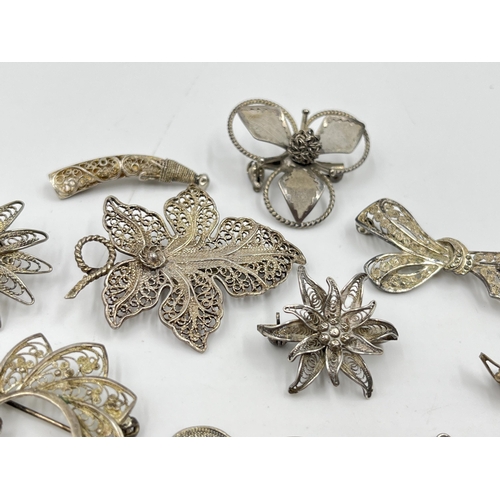 2096 - A collection of silver and white metal filigree jewellery to include .835 bow brooch, .835 leaf broo... 