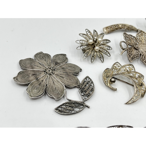 2096 - A collection of silver and white metal filigree jewellery to include .835 bow brooch, .835 leaf broo... 