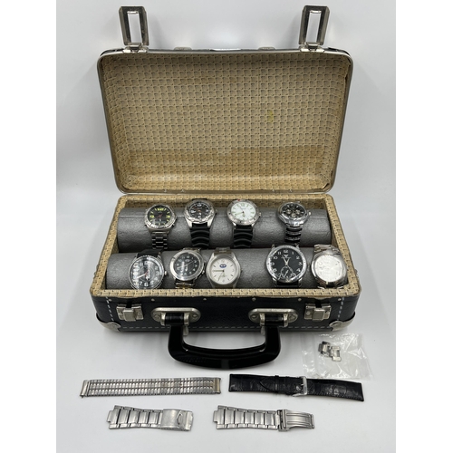 2183 - A leatherette watch storage case containing nine quartz wristwatches to include Emporio Armani, two ... 