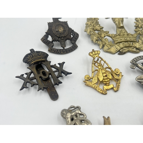 2239 - Ten military cap badges to include Loyal North Lancashire, East Lancashire, Canada, The Royal Sussex... 