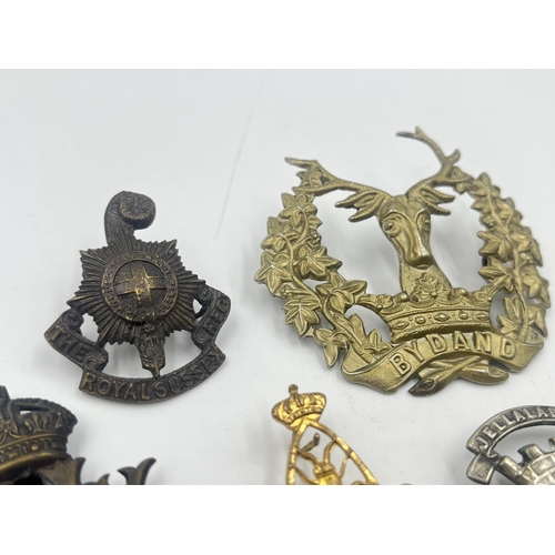 2239 - Ten military cap badges to include Loyal North Lancashire, East Lancashire, Canada, The Royal Sussex... 