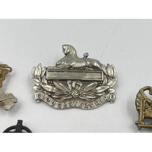 2241 - Ten military cap badges to include Somerset & Cornwall, Gloucestershire, National Defence Company, R... 