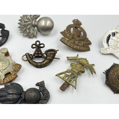 2242 - Ten military cap badges to include Winnipeg Light Infantry, Army Legal Corps, The Royal Sussex Regim... 