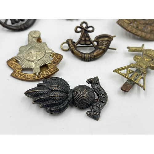 2242 - Ten military cap badges to include Winnipeg Light Infantry, Army Legal Corps, The Royal Sussex Regim... 