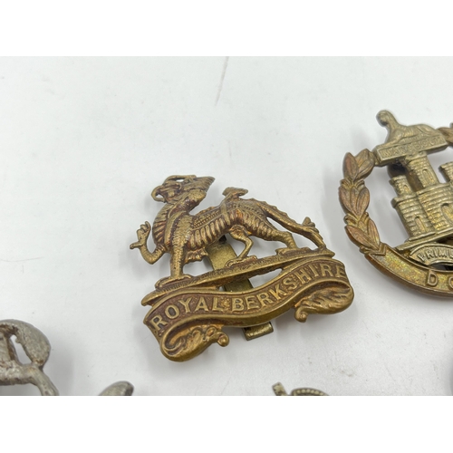 2244 - Ten military cap badges to include Royal Berkshire, Dorset, Jellalabad, South Staffordshire, East La... 