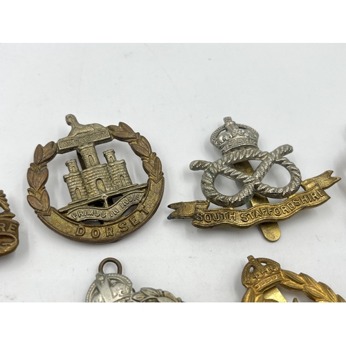 2244 - Ten military cap badges to include Royal Berkshire, Dorset, Jellalabad, South Staffordshire, East La... 