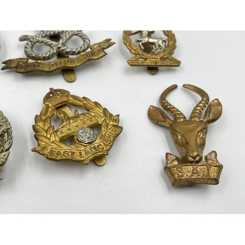 2244 - Ten military cap badges to include Royal Berkshire, Dorset, Jellalabad, South Staffordshire, East La... 