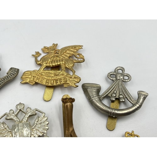 2245 - Ten military cap badges to include The Buffs, The Royal Dragoons, Northamptonshire, Kaffrarian Rifle... 