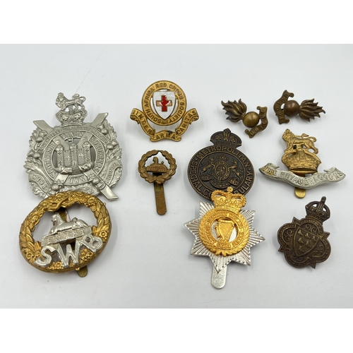 2246 - Ten military cap badges to include Scottish King's Borderers Own, The Royal Dragoons, Metropolitan S... 