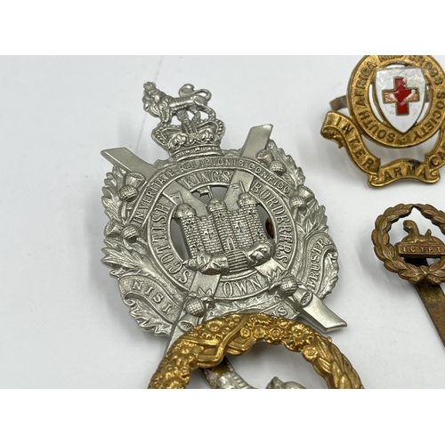 2246 - Ten military cap badges to include Scottish King's Borderers Own, The Royal Dragoons, Metropolitan S... 