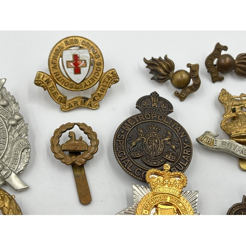 2246 - Ten military cap badges to include Scottish King's Borderers Own, The Royal Dragoons, Metropolitan S... 