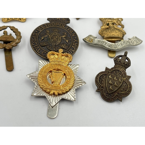 2246 - Ten military cap badges to include Scottish King's Borderers Own, The Royal Dragoons, Metropolitan S... 