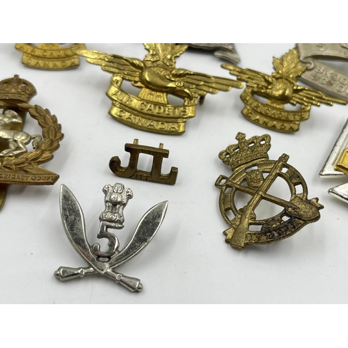 2247 - Twelve military cap badges to include Air Cadets Canada, South African School Cadets, Royal Army Vet... 