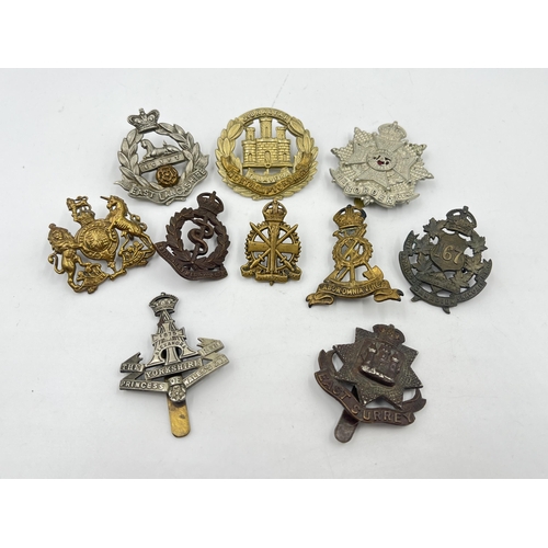 2248 - Ten military cap badges to include East Surrey, Northamptonshire, The Border Regiment, The Yorkshire... 