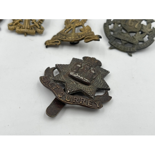 2248 - Ten military cap badges to include East Surrey, Northamptonshire, The Border Regiment, The Yorkshire... 