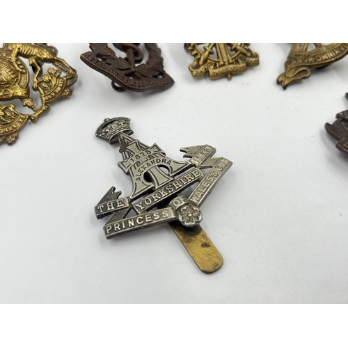 2248 - Ten military cap badges to include East Surrey, Northamptonshire, The Border Regiment, The Yorkshire... 