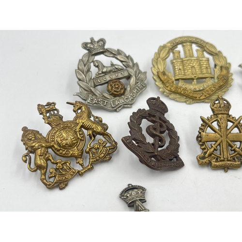 2248 - Ten military cap badges to include East Surrey, Northamptonshire, The Border Regiment, The Yorkshire... 