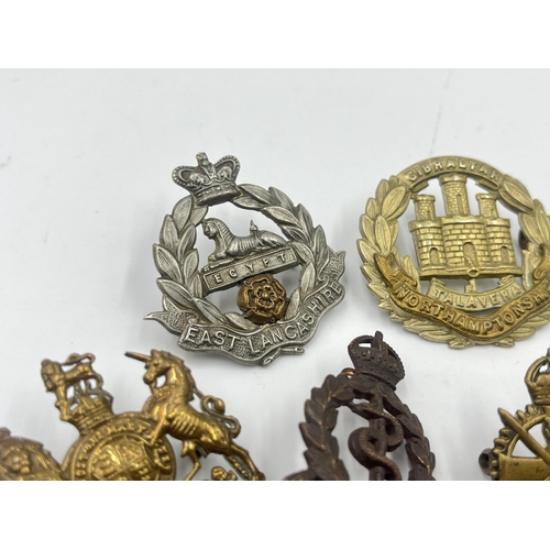 2248 - Ten military cap badges to include East Surrey, Northamptonshire, The Border Regiment, The Yorkshire... 