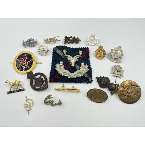 2249 - A collection of military badges to include Canadian Garrison Regiment, North Somerset Yeomanry etc.