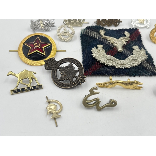 2249 - A collection of military badges to include Canadian Garrison Regiment, North Somerset Yeomanry etc.