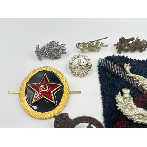 2249 - A collection of military badges to include Canadian Garrison Regiment, North Somerset Yeomanry etc.