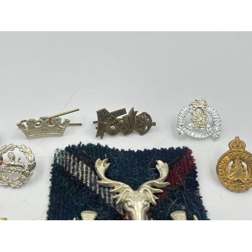 2249 - A collection of military badges to include Canadian Garrison Regiment, North Somerset Yeomanry etc.