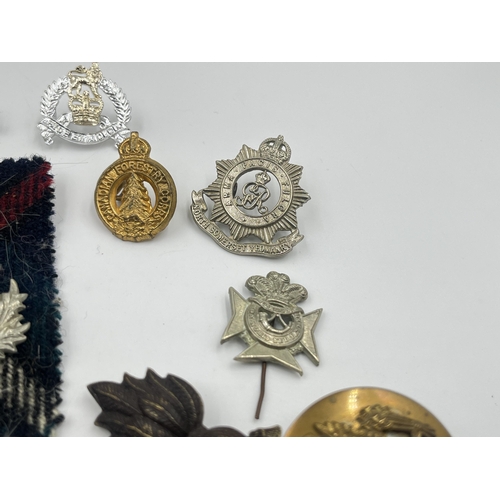 2249 - A collection of military badges to include Canadian Garrison Regiment, North Somerset Yeomanry etc.