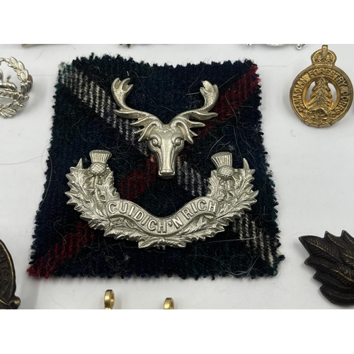 2249 - A collection of military badges to include Canadian Garrison Regiment, North Somerset Yeomanry etc.