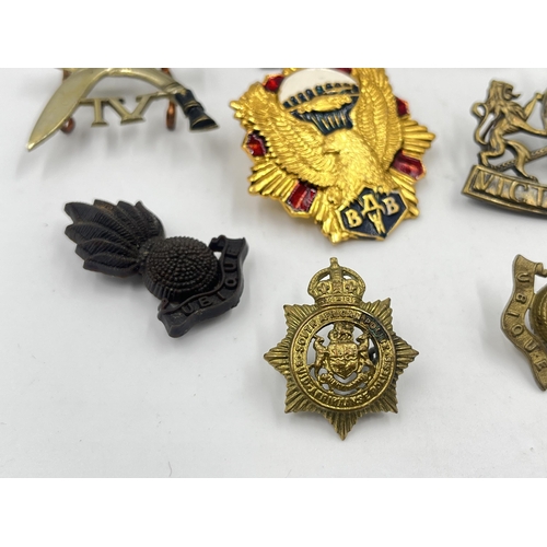 2251 - Ten military cap badges to include Worcestershire, Royal Army Ordnance Corps etc.