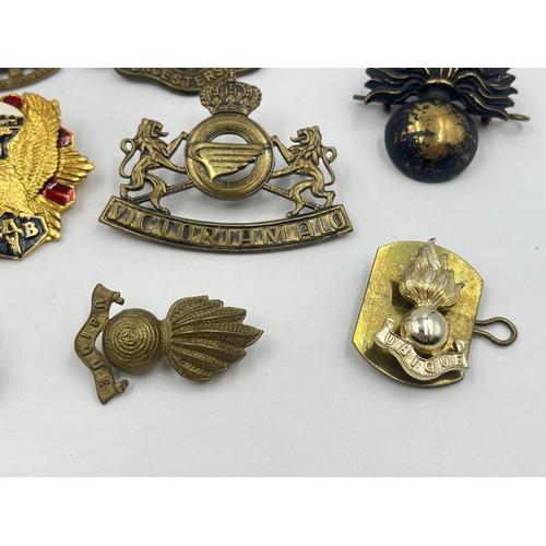 2251 - Ten military cap badges to include Worcestershire, Royal Army Ordnance Corps etc.