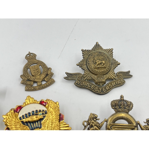 2251 - Ten military cap badges to include Worcestershire, Royal Army Ordnance Corps etc.