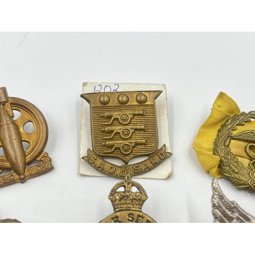 2252 - Six military cap badges to include South African Technical Service Corps, WWI On War Service 1915, S... 