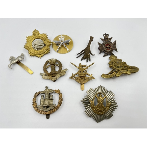 2260 - Ten military cap badges to include Middlesex Regiment, The Royal Scots, Dorsetshire etc.