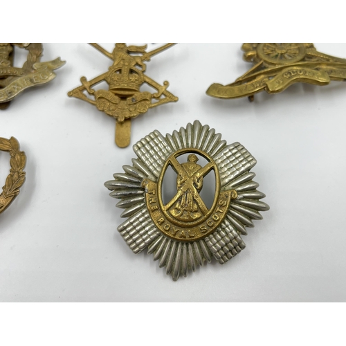 2260 - Ten military cap badges to include Middlesex Regiment, The Royal Scots, Dorsetshire etc.