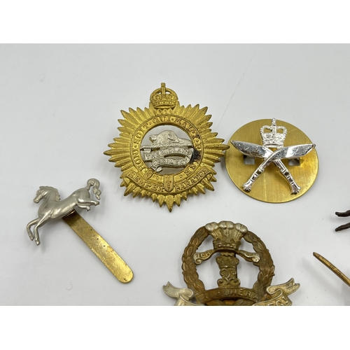 2260 - Ten military cap badges to include Middlesex Regiment, The Royal Scots, Dorsetshire etc.