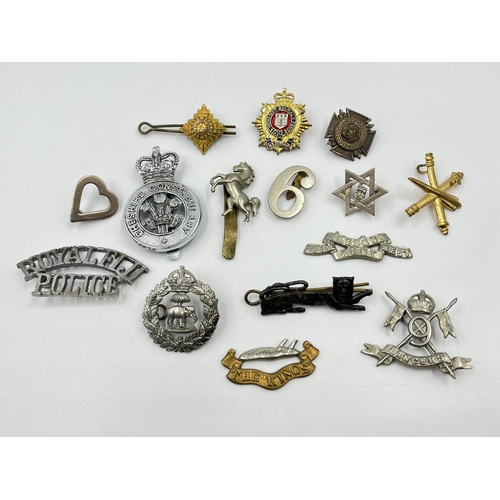 2261 - A collection of military and police cap badges to include Royal Fiji Police, Royal Kent West, Cheshi... 