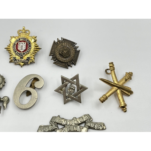 2261 - A collection of military and police cap badges to include Royal Fiji Police, Royal Kent West, Cheshi... 